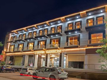 AHR Omnibliss hotel's exterior lit beautifully at night, showcasing its modern architecture.