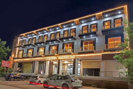 AHR Omnibliss hotel's exterior lit beautifully at night, showcasing its modern architecture.
