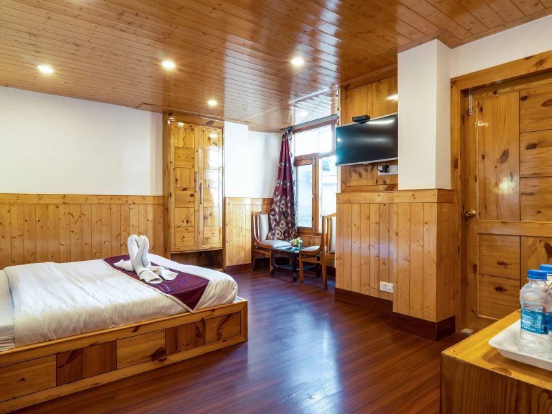 Elegant wooden interior of a guest room in AHR Windsor Hotel, Shimla.