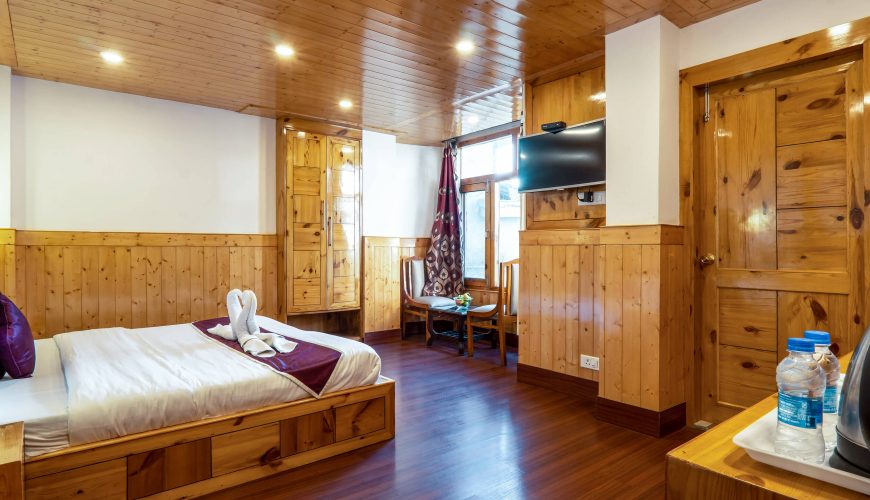 Elegant wooden interior of a guest room in AHR Windsor Hotel, Shimla.