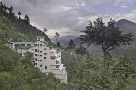 Picturesque exterior view of Hotel Himalayan Monal, nestled in the lush greenery of Manali